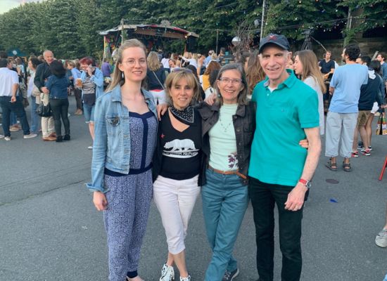 Georgia Aussenac standing together with her retiree students Sharon, Corinne and Ted, at outdoor music concert Rock U en Seine in 2019