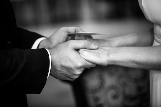 Georgia and her husband's hands clasped together, in black and white.