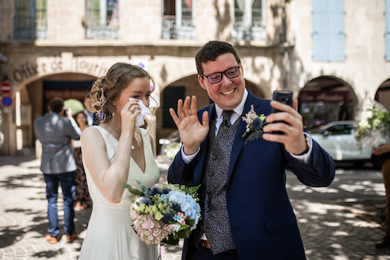 Georgia and her husband waving and crying at a FaceTime call.