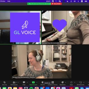 A zoom screenshot of Georgia Aussenac at her keyboard with her baby on her knees, the image of her student blocked out with the GL Voice bird logo on the bright purple background.